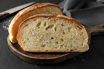 Pieces of fresh bread on black table, closeup