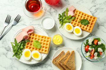 Flat lay composition with tasty brunch served on white marble table