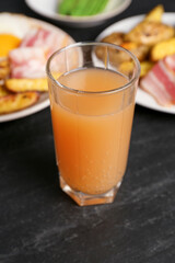 Tasty brunch. Refreshing drink and dishes on dark textured table, closeup