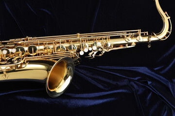 Obraz premium Jazz. One beautiful saxophone on dark blue fabric