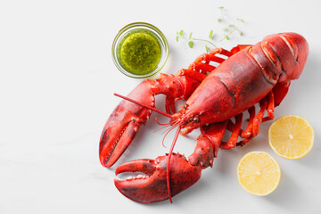 Delicious boiled lobster with oil, microgreens and lemon pieces on white table, flat lay