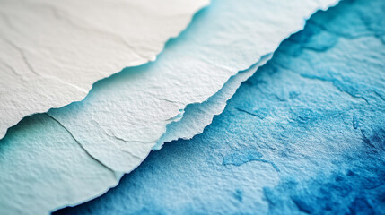 Close-up of layered textured paper in shades of blue and white, showcasing intricate details and subtle color variations.
