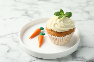 Delicious carrot cupcake with mint on white marble table, closeup