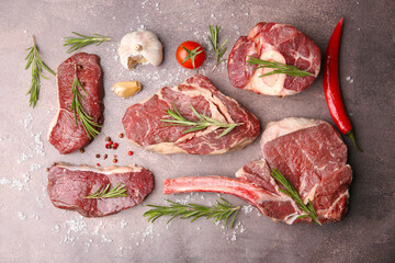 Flat lay composition with pieces of raw beef, salt, rosemary and products on brown textured table