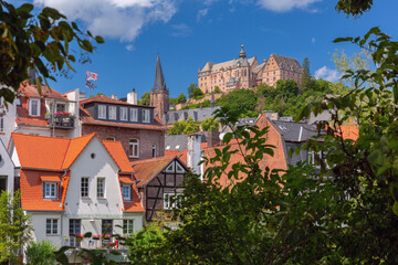 Landgrafenschloss castle on hill above traditional fachwerk houses in Marburg Germany on a sunny summer day
