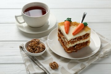 Delicious homemade carrot cake served on white wooden table