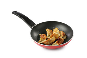 Tasty fried gyoza (dumplings) in frying pan isolated on white