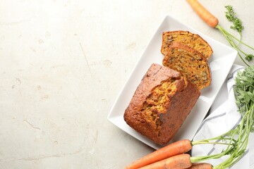 Homemade carrot cake with nuts and vegetables on light grey table, flat lay. Space for text