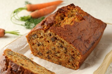 Homemade carrot cake with nuts and vegetables on table, closeup