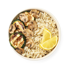 Delicious brown rice with mushrooms, zucchini and lemon slices isolated on white