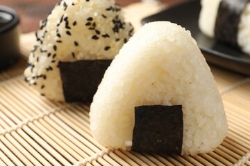 Rice balls (onigiri) on table, closeup. Traditional Japanese dish