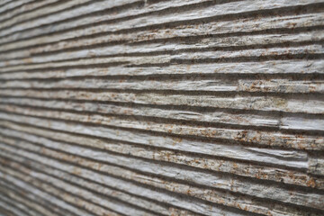 Rough, grooved stone wall background