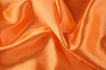 Luxurious Orange Satin Fabric with Smooth and Shiny Finish. Silky background.