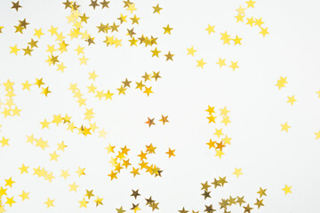 Golden Star Confetti on White Background.