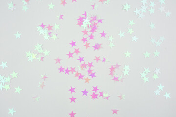 Pink and Holographic Star Confetti on White Background.