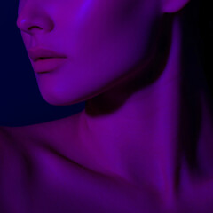 Abstract portrait of young female in vibrant purple lighting