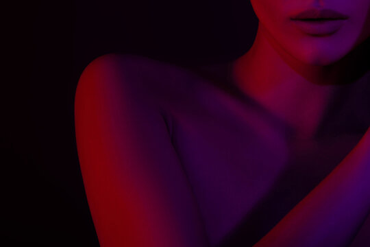 Close-up of female silhouette with bold red and purple lighting