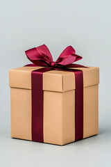 Obraz premium Tan gift box with a burgundy ribbon