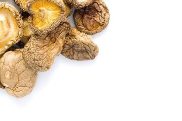 An elegant composition of dried shiitake mushrooms on white, emphasizing natural texture and earthy, umami colors.