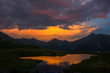 Sunset over lake Flecknersee at Jaufenpass mountain in south tyrol