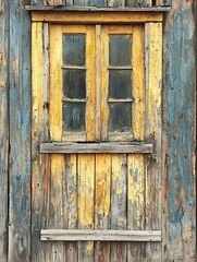 Rustic Charm: A Weathered Wooden Window