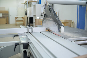 Circular saw blade on panel saw machine in woodworking workshop