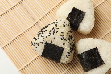 Rice balls (onigiri) on table, flat lay. Traditional Japanese dish