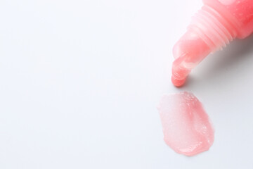 Tube of lip balm and sample on white background, top view. Space for text