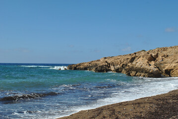 landscape photo, sea waves crashing against a rocky shore