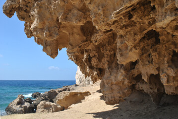 photo of seascape, hanging rock above sandy beach, Cyprus