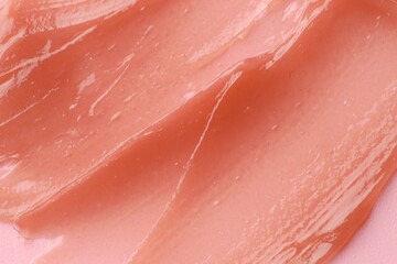 Moisturizing lip balm on pink background, above view