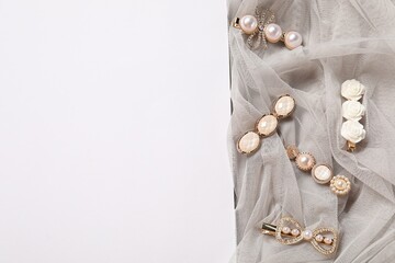 Beautiful hair clips and tulle fabric on white background, flat lay. Space for text