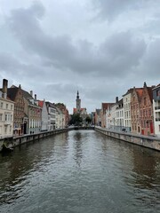picturesque view of one of Bruges' iconic canals, lined with charming historic buildings that showcase the city's medieval architecture.
