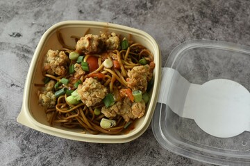 Crispy pork and pan fried noodles with sweet and sour sauce.