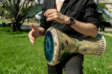 Hands of a percussionist playing his derbake or darbuka of Arabic origin