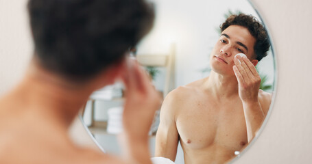 Cotton pad, mirror and man in bathroom, skincare and dermatology with routine, wellness and beauty. Person, house and guy with reflection, cleanse and cosmetics with treatment and swab for acne © peopleimages.com