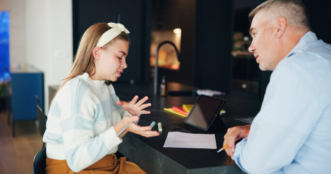 Girl, dad and daughter with homework or tablet screen for tutoring, learning or education at home. Teenager, father and helping child with paper or preparation for test, exam or assessment at house