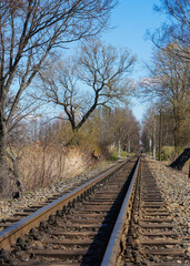Obraz premium Railroad tracks for excursion steam train in city park. Ideal for theme of urban leisure, children entertainment.