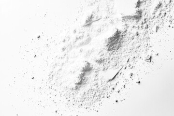 Fototapeta premium White powder scattered on a white background, showing texture and small pieces.