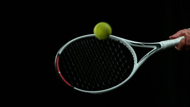 Super Slow Motion Detail Shot of Hitting Tenis Ball by Racket at 1000 fps.
