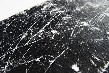 Abstract black and white texture with splatters and streaks of paint, creating a dynamic visual.