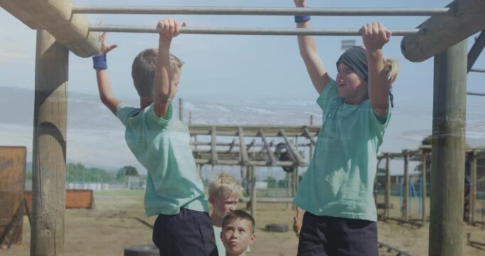 Playing on monkey bars, children enjoying animation at outdoor school playground