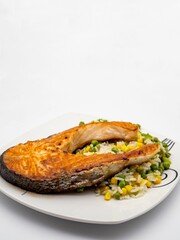 Grilled salmon steak with rice and vegetables.