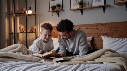 Father and son sharing cozy storytime moments in bed - Powered by Adobe
