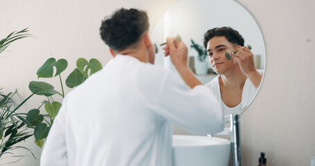 Mirror, man and face roller for skincare, self care and morning in home bathroom. Beauty, jade...