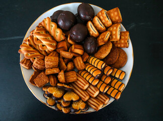 A vibrant assortment of homemade cookies and snacks arranged beautifully on a white plate