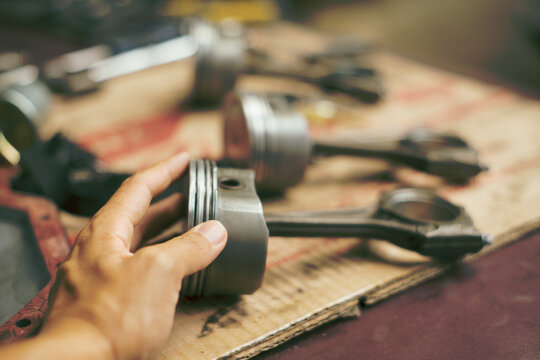 Replacing pistons in a car engine during maintenance