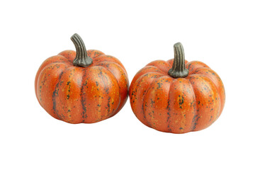 Fototapeta premium Two small orange pumpkins with variegated stripes on black background, cut out
