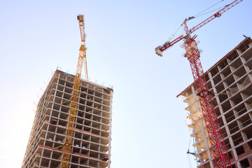 A bustling Construction Site showcasing Cranes, Building Framework, and full activity all around