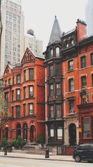 Fototapeta premium City street, red brick row houses, urban architecture, background skyscrapers, real estate